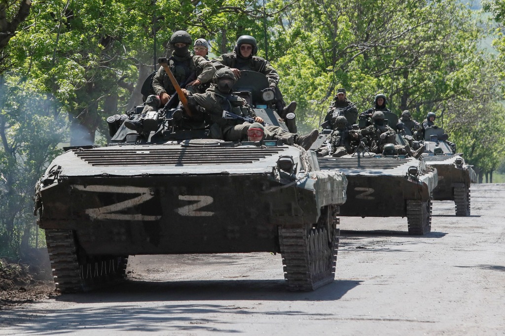 Um comboio de veículos blindados russos percorre uma estrada no contexto do conflito ucraniano-russo perto de Mariupol em 20 de maio. 