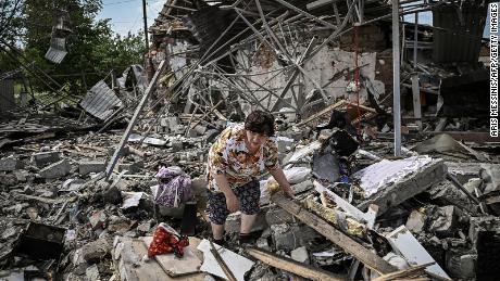 Moradores procuram pertences sob os escombros de suas casas depois que um ataque destruiu três casas na cidade de Slovensk, na região de Donbass, no leste da Ucrânia, em 1º de junho.